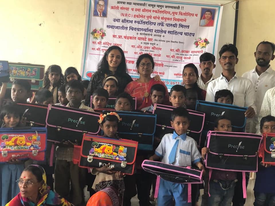 Sunita standing next to Uma Sriram (Left), alongside young children who will benefit from their work. 