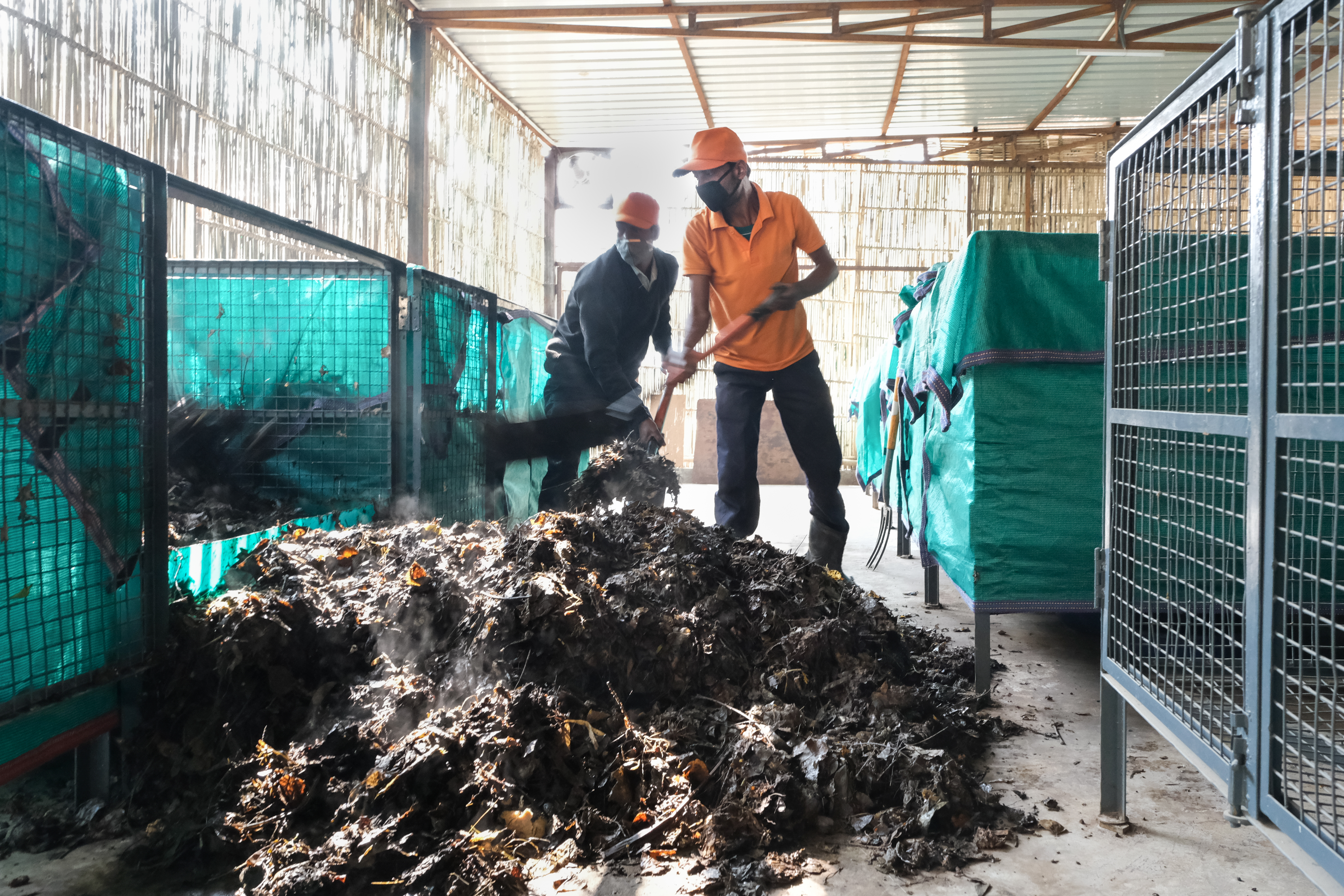 Churning compost at the “on-site" composting centre. (Source: Saahas)