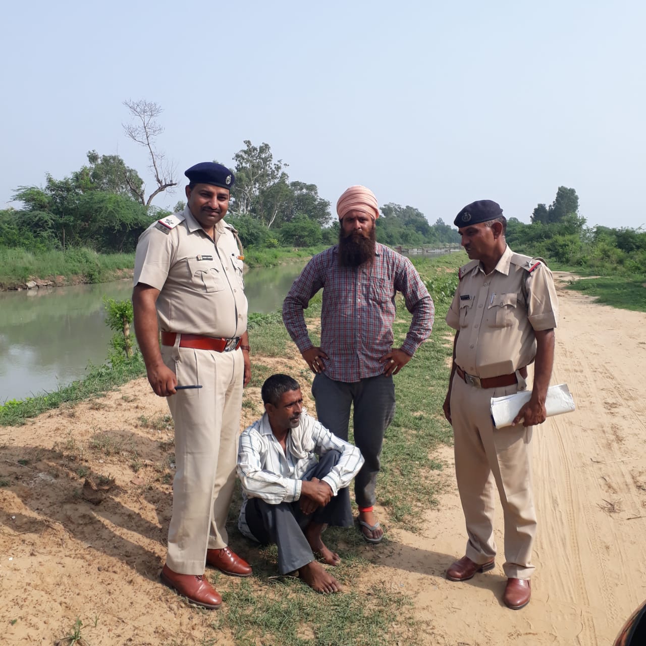 Pargat Singh (In a turban) with a man he saved, alongside local police personnel. (Source: Pargat Singh)