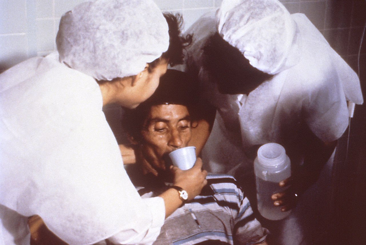 Cholera patient drinking ORS. (Source: Wikimedia Commons)