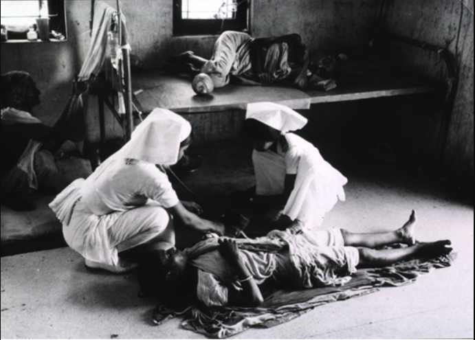 Nurses treating a cholera patient. (Source: WHO)