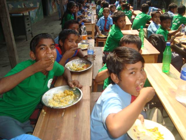 Young students enjoying the mid-day meal. (Source: Facebook/CECS)