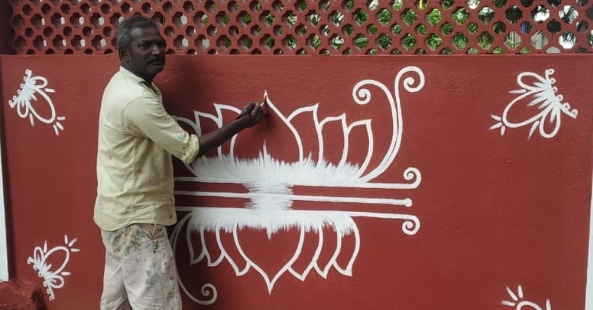 artist drawing kolams