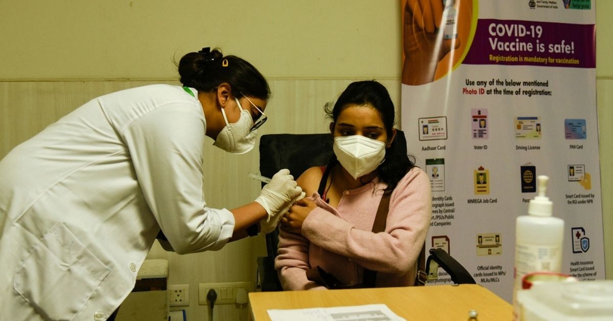 A lady getting her booster shot. 