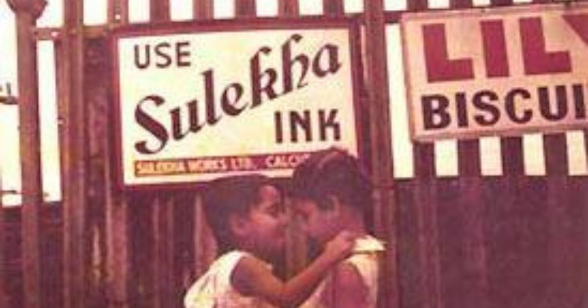 Two boys playing in front of Sulekha ad