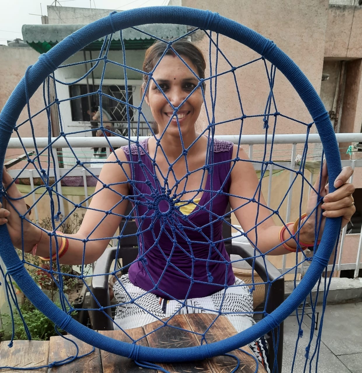 Pooja Kant, holding handmade Macrame art. 