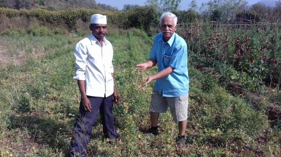 Bhadsavle, aka 'dada', with a farmer in Maharashtra