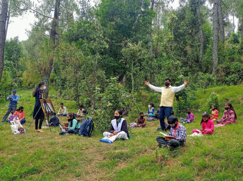 Kalyan Mankoti while holding his class in a field.