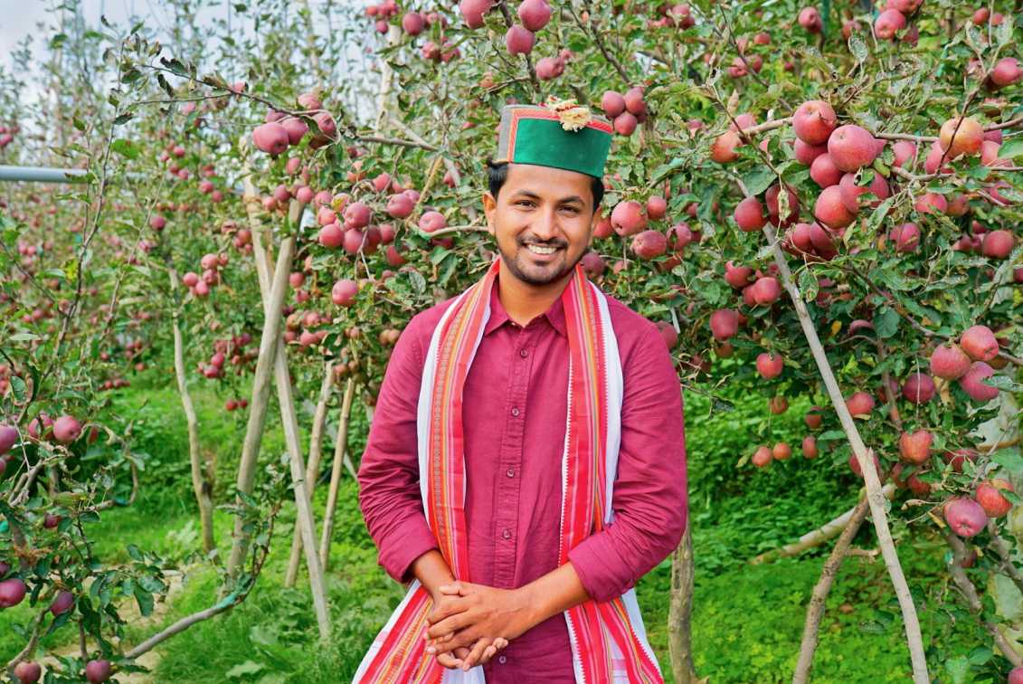 Santosh Jadhav, co-founder of Indian Farmer, in an apple orchard