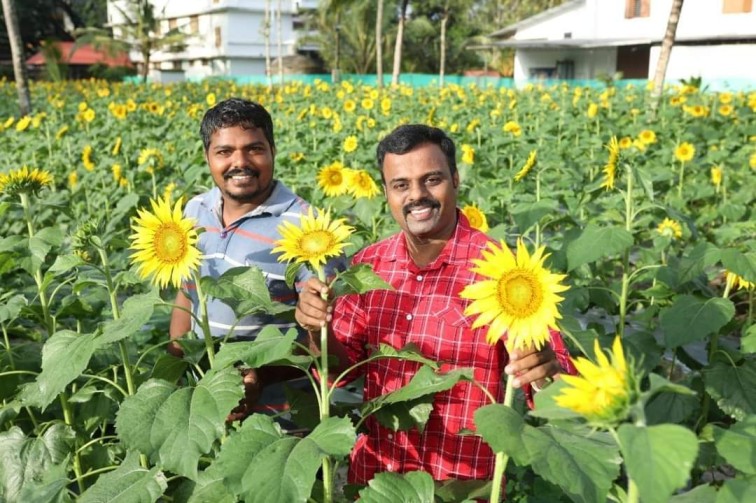 Sujith with his farming assistant, Sunil Kumar KM