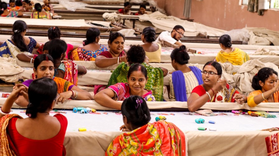 Women embroiderers working on a sari at Prastuti Designs