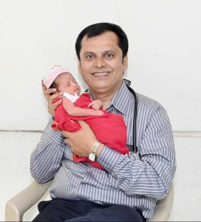 Dr Ganesh Rakh with a baby girl