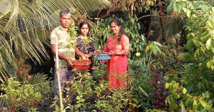 Joseph Lobo with his family on his terrace garden where he grows jasmine plants using hydroponics method