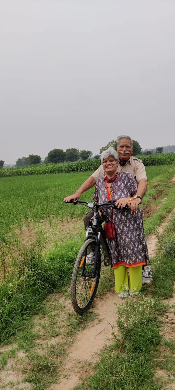 A senior citizen couple on a cycle