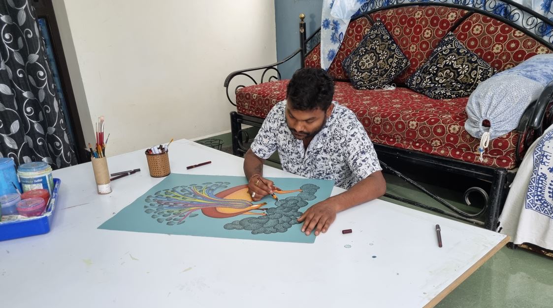 Mayank Singh Shyam, son of Tribe Artist Jangarh Singh Shyam, painting at his home