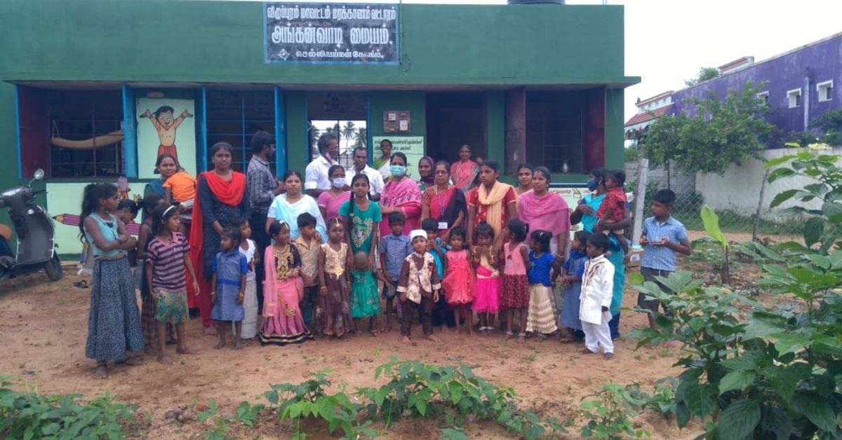 Children and parents with Sumathi in front of the renovated anganwadi