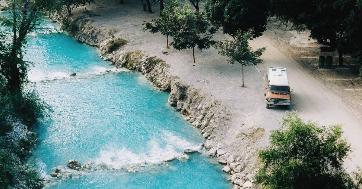 campervan parked near a remote lake