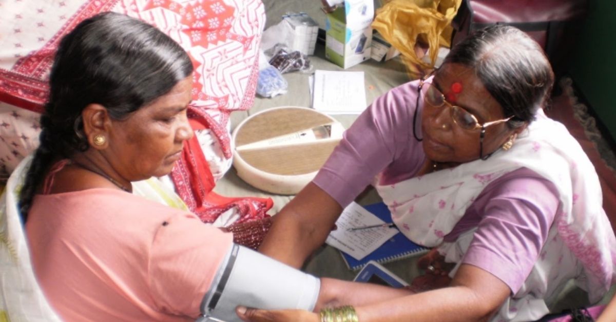 two village women examine one another for health check ups in rural maharashtra