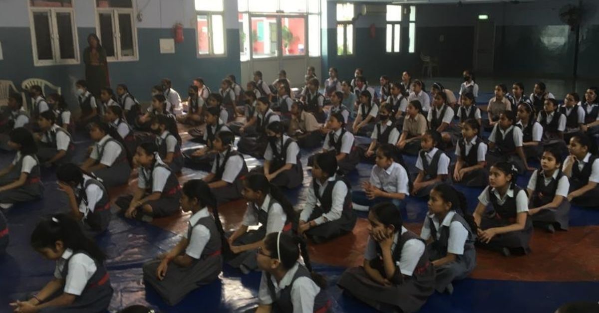 girl students in uniform sit in rows while attending a period workshop organised by whisper