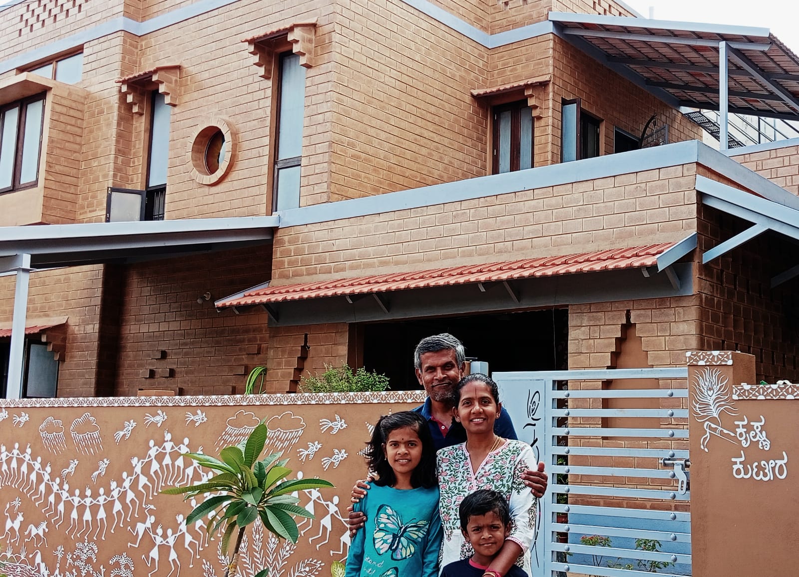 The family in front of their sustainable home in Bengaluru.
