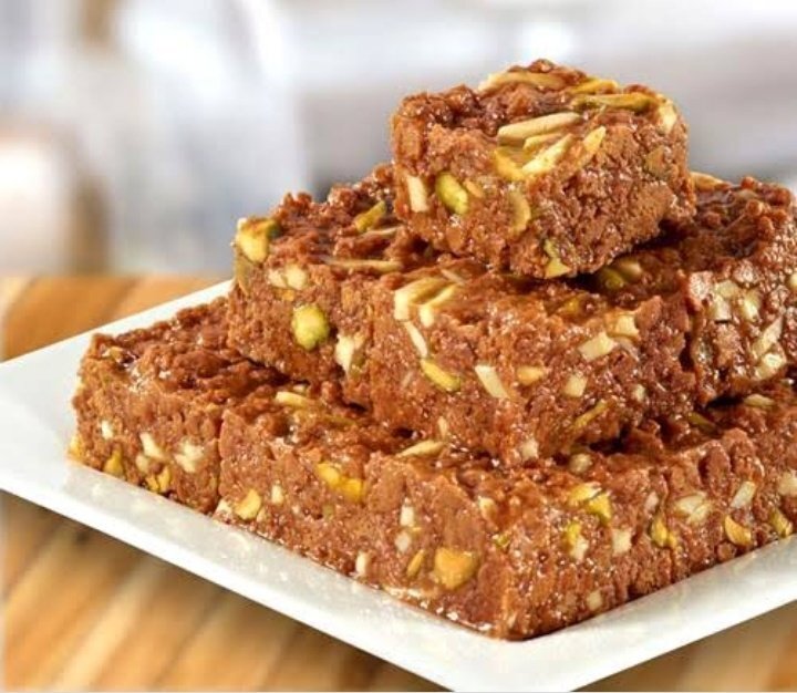 Dodha Barfi stacked on a white plate 