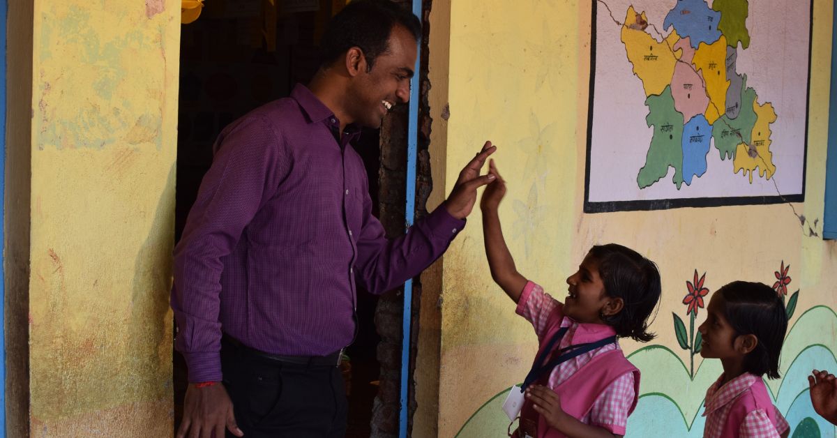teacher ranjitsingh high fiving a girl student