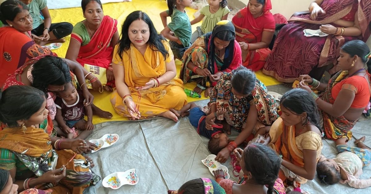 Anita Gupta surrounded by a group of women