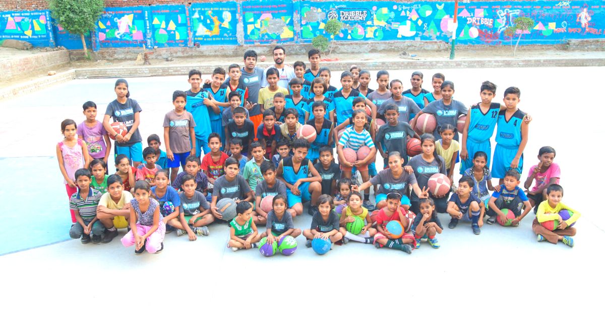 Basketball coach with his Dribble Academy family