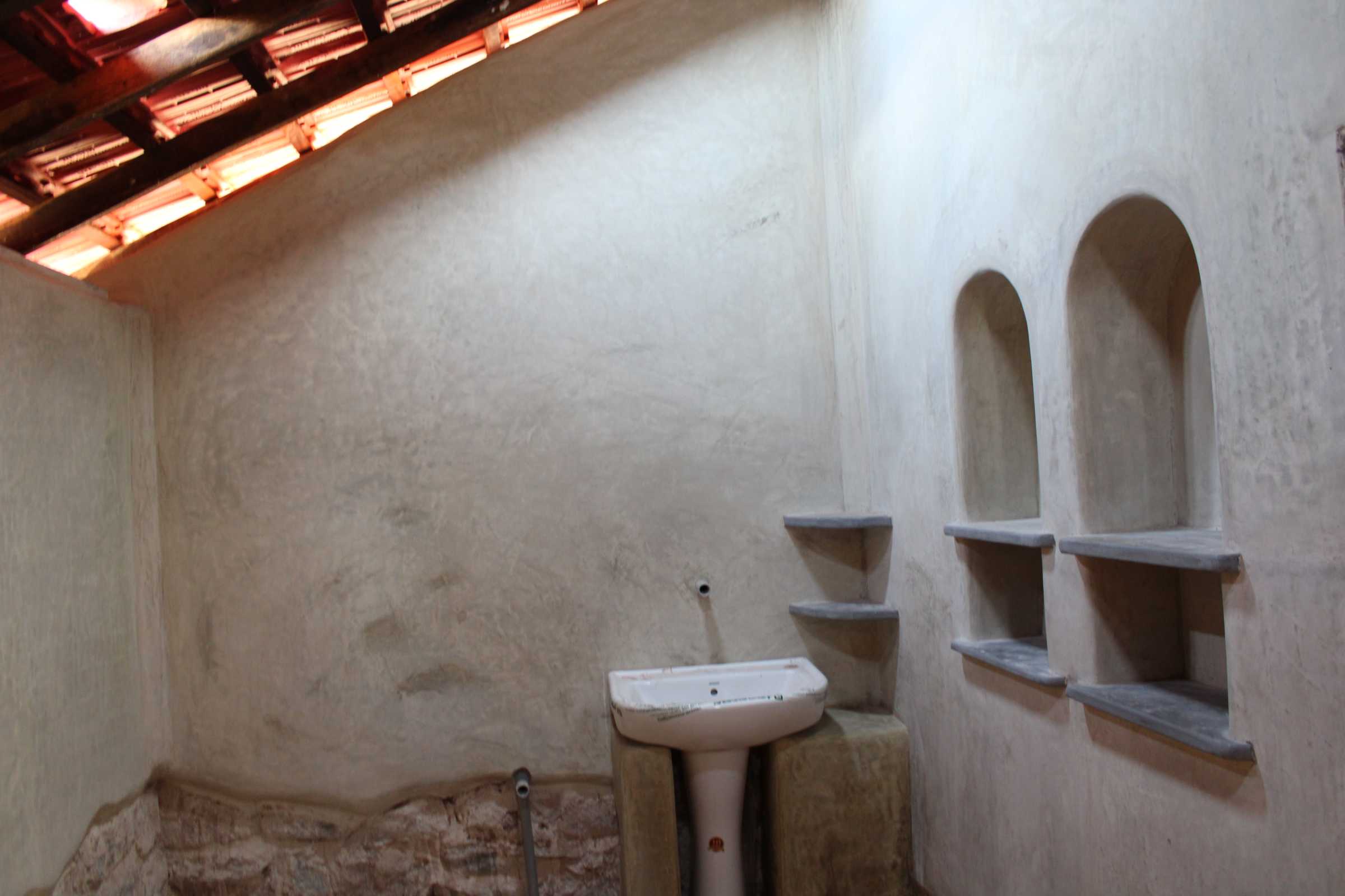 Plastered walls inside the washroom.