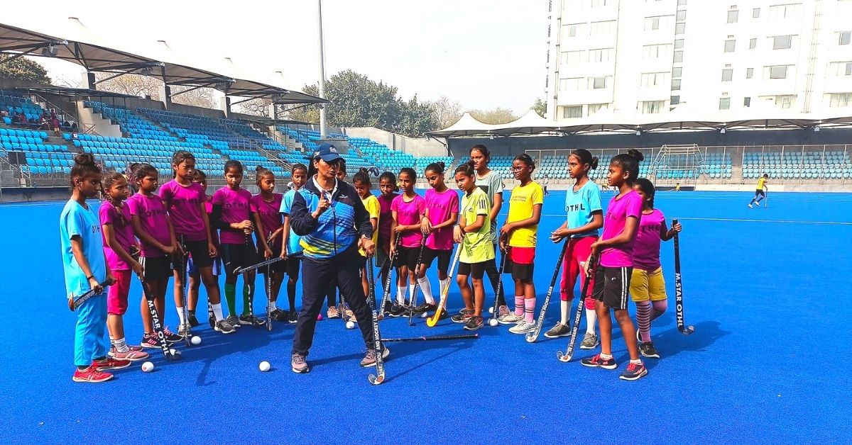 Pritam Rani Siwach teaching hockey to young girls