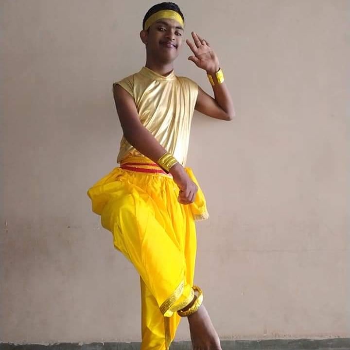 Bhavnish Aggarwal, a self advocate at Chaanan, poses in his yellow outfit