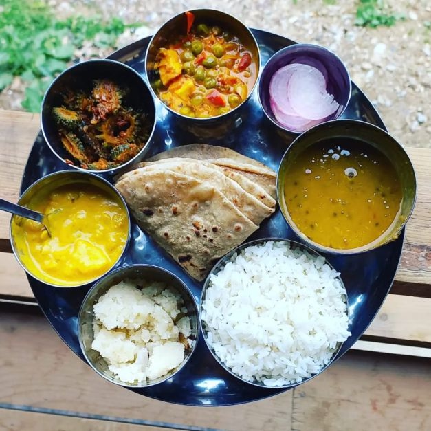 a colourful plate of indian food at eco friendly home stay in sainj valley 