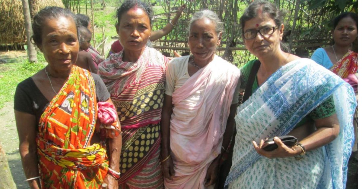 kolkata educator chandra mukhopadhyay stands next to rural women folk singers