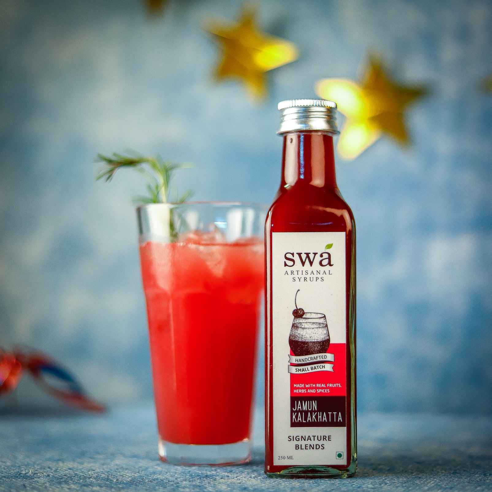 swa artisinal syrup in jamun kala khatta flavour with a glass of red coloured juice 