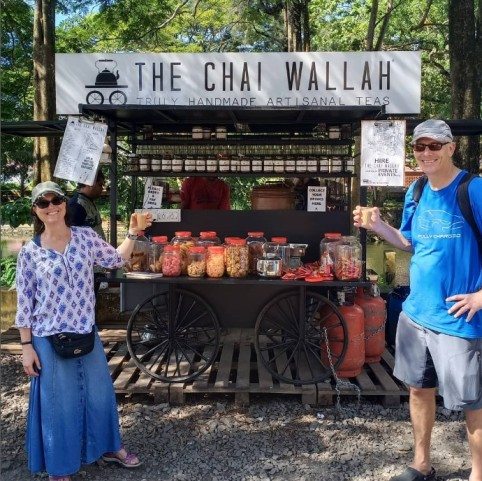 customers enjoy a cup of tea outside a tea stall named the chai wallah 