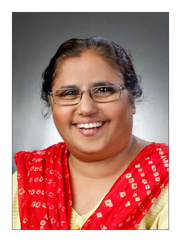 jameela nishat, founder of shaheen, clad in yellow kurta with a red dupatta. 