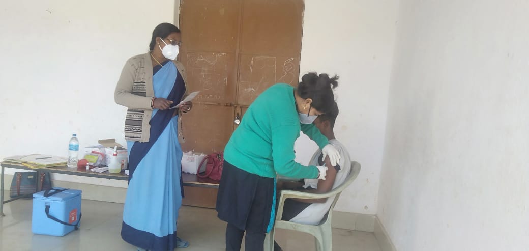 During a vaccination drive, Matilda an ASHA worker oversees inoculation of a man. 