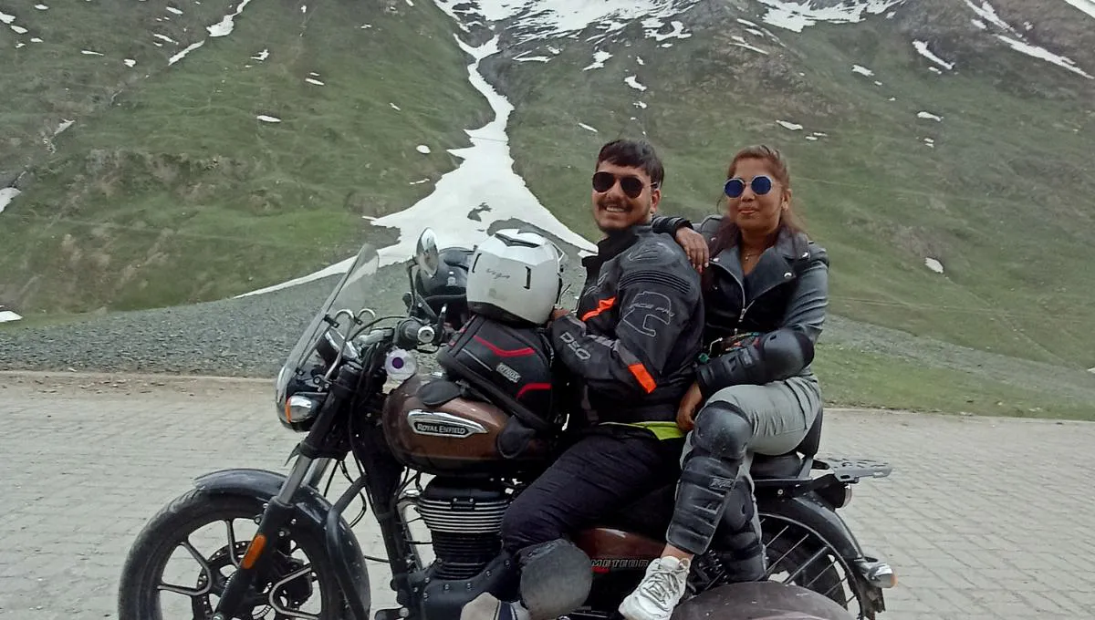 a man and woman sit on a bike on their way to ladakh 