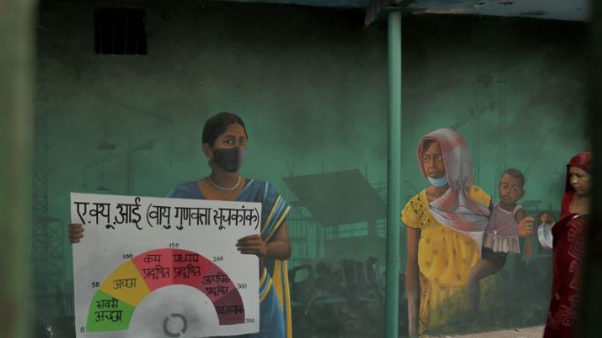 A mural in Delhi shows women participating in AQI measuring process