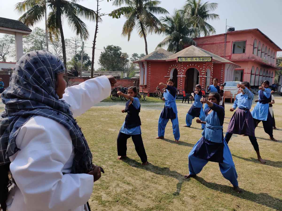 Girls at the local school being taught self defence techniques.