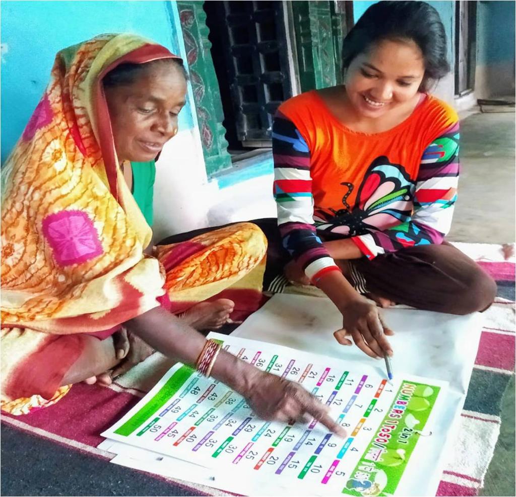 A volunteer teaches arithmetic in a mandala. 