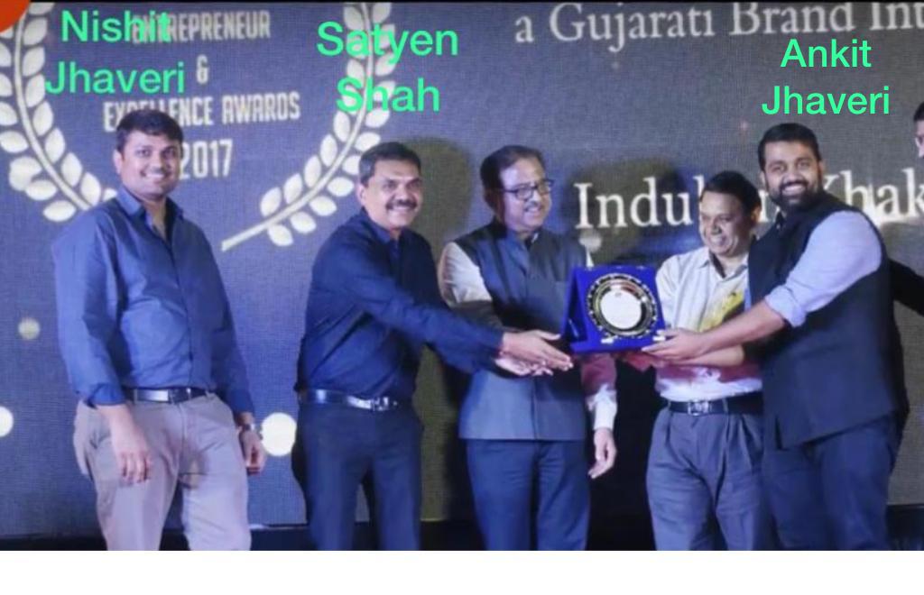 Nishit Jhaveri, Satyen Shah and Ankit Jhaveri receiving an award. 