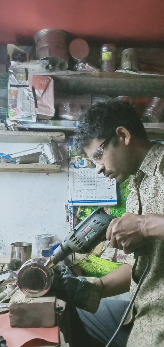 Basant working on his innovation to help make mangodi's/bhajjiya  faster. 
