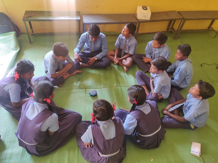 Students pose their questions to Alexa at a school in Bastar