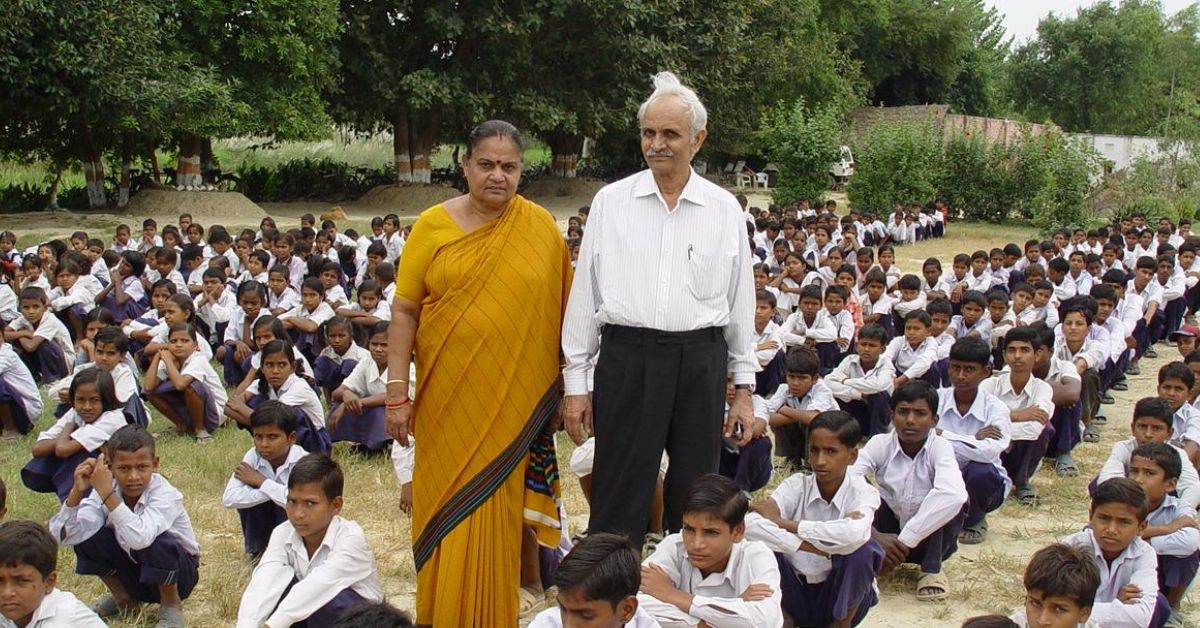 geologist s b misra and teacher nirmala misra, who started the bharatiya gramin vidyalaya school in a village in uttar pradesh, stand among rows of school students