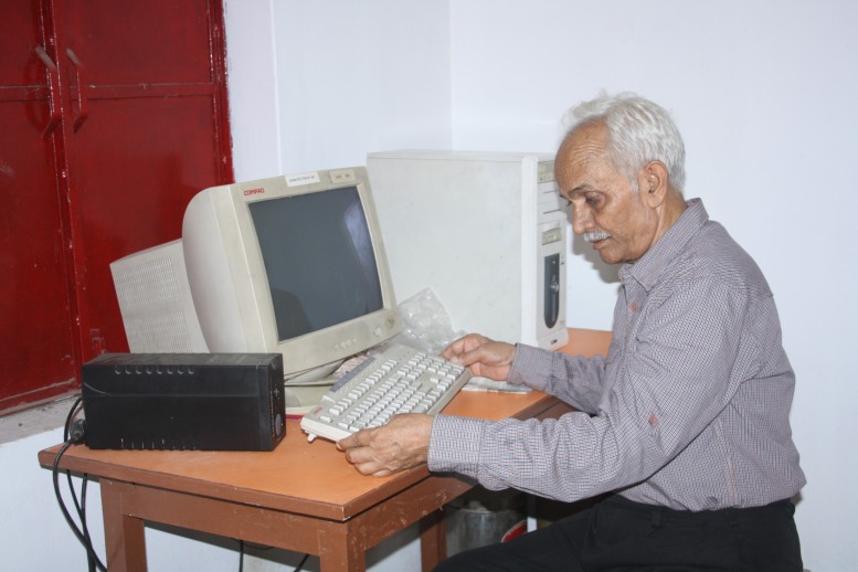 geologist and social worker Dr S B Misra sits at a computer desk at the Bharatiya Gramin Vidyalaya in Uttar Pradesh 