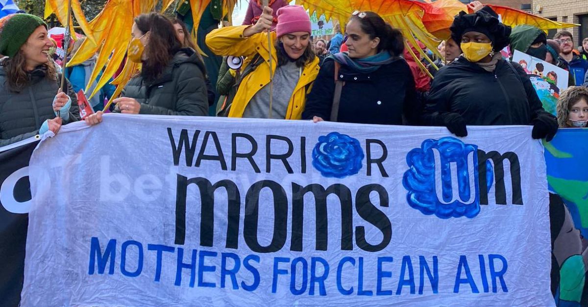 women from delhi, part of a collective known as warrior moms, attend the COP26 in Gaslgow holding banners calling for clean air in delhi