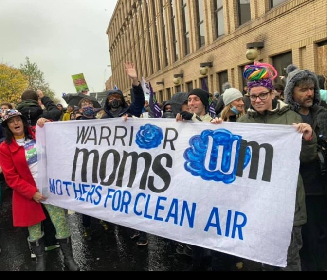 women from india, part of a collective known as warrior moms, attend the COP26 in Gaslgow holding banners calling for clean air in delhi  