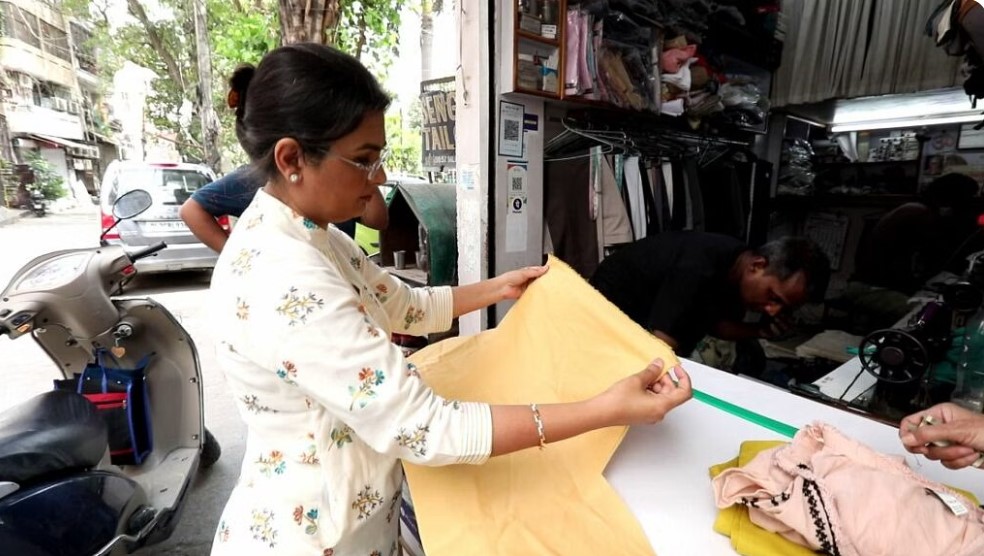 dr ruby checking the clothes to be converted into cloth bags as part of vikalp project