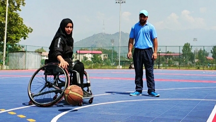 Ishrat Akther being coached for a game of basketball